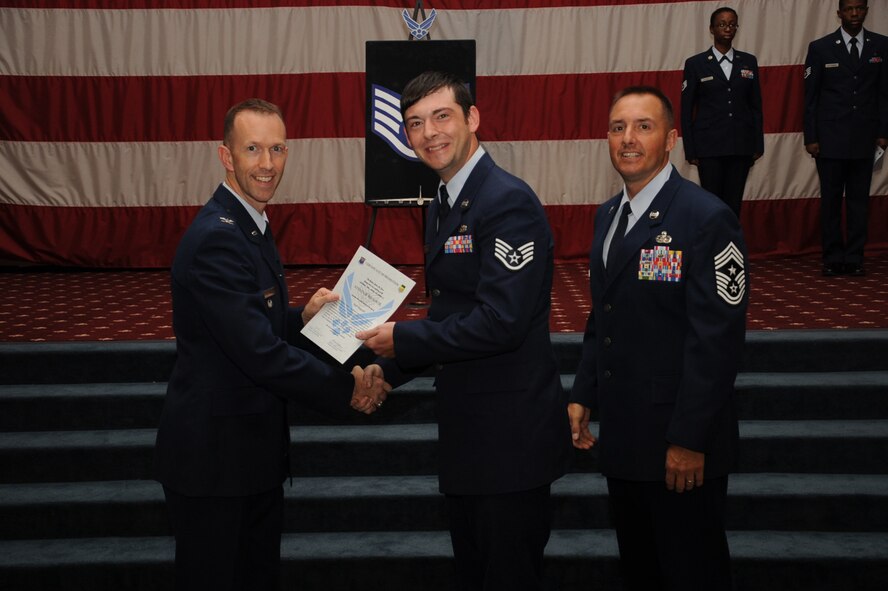 Staff Sgt. Steven Wilson, 2nd Maintenance Squadron, receives a certificate of promotion from Col. Leland Bohannon, 2nd Bomb Wing vice commander, and Chief Master Sgt. Curtis Storms, 2nd Bomb Wing command chief, during the September Wing Promotion Ceremony on Barksdale Air Force Base, La., Sept. 30, 2013. (U.S. Air Force photo/Senior Airman Sean Martin)