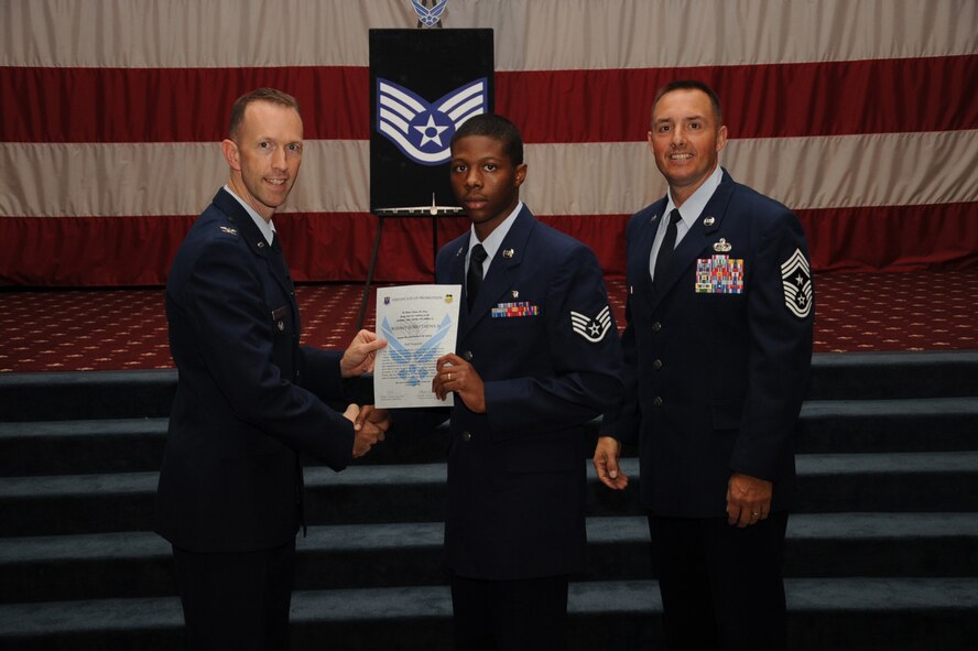 Staff Sgt. Rodney Matthews, 2nd Dental Squadron,  receives a certificate of promotion from Col. Leland Bohannon, 2nd Bomb Wing vice commander, and Chief Master Sgt. Curtis Storms, 2nd Bomb Wing command chief, during the September Wing Promotion Ceremony on Barksdale Air Force Base, La., Sept. 30, 2013. (U.S. Air Force photo/Senior Airman Sean Martin)