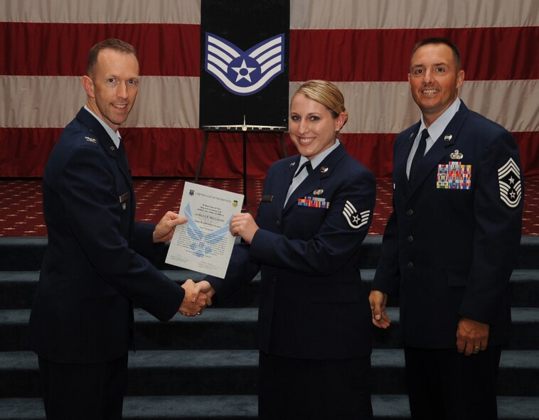 Staff Sgt. Ashley Williams, 2nd Communication Squadron,  receives a certificate of promotion from Col. Leland Bohannon, 2nd Bomb Wing vice commander, and Chief Master Sgt. Curtis Storms, 2nd Bomb Wing command chief, during the September Wing Promotion Ceremony on Barksdale Air Force Base, La., Sept. 30, 2013. (U.S. Air Force photo/Senior Airman Sean Martin)