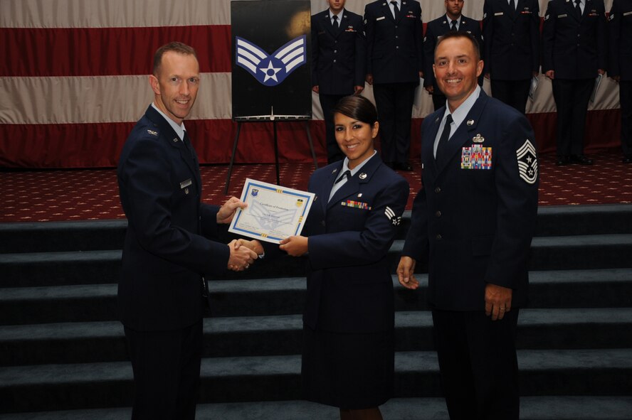 Senior Airman Lucy Baxter, 2nd Medical Operations Squadron, receives a certificate of promotion from Col. Leland Bohannon, 2nd Bomb Wing vice commander, and Chief Master Sgt. Curtis Storms, 2nd Bomb Wing command chief, during the September Wing Promotion Ceremony on Barksdale Air Force Base, La., Sept. 30, 2013. (U.S. Air Force photo/Senior Airman Sean Martin)