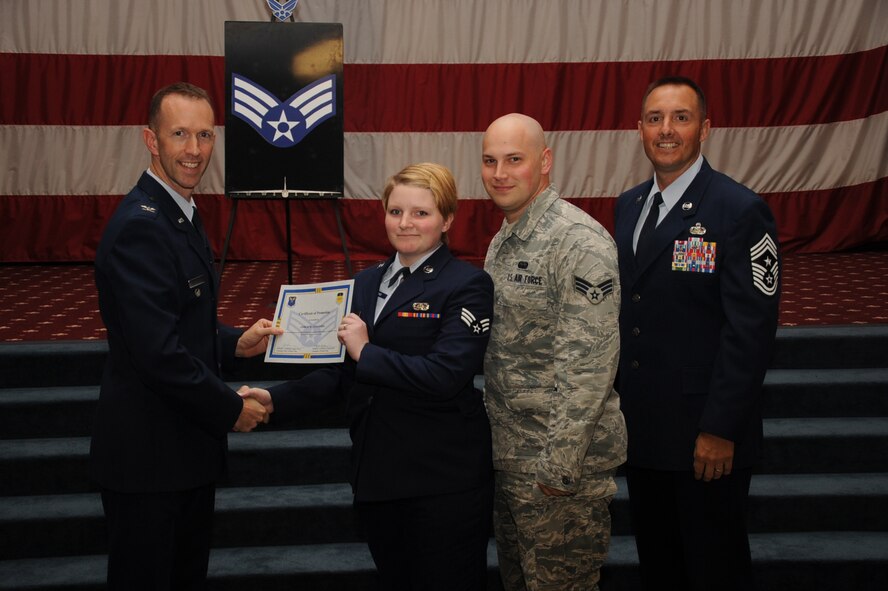 Senior Airman Amber Stafford, 2nd Communications Squadron, receives a certificate of promotion from Col. Leland Bohannon, 2nd Bomb Wing vice commander, and Chief Master Sgt. Curtis Storms, 2nd Bomb Wing command chief, during the September Wing Promotion Ceremony on Barksdale Air Force Base, La., Sept. 30, 2013. (U.S. Air Force photo/Senior Airman Sean Martin)