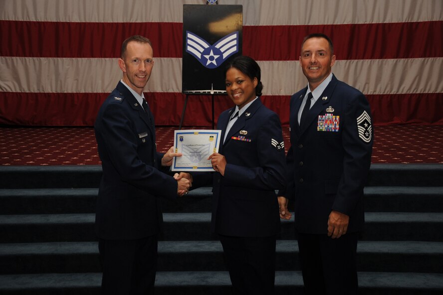 Senior Airman Jocelyn Allen, 2nd Bomb Wing, receives a certificate of promotion from Col. Leland Bohannon, 2nd Bomb Wing vice commander, and Chief Master Sgt. Curtis Storms, 2nd Bomb Wing command chief, during the September Wing Promotion Ceremony on Barksdale Air Force Base, La., Sept. 30, 2013. (U.S. Air Force photo/Senior Airman Sean Martin)