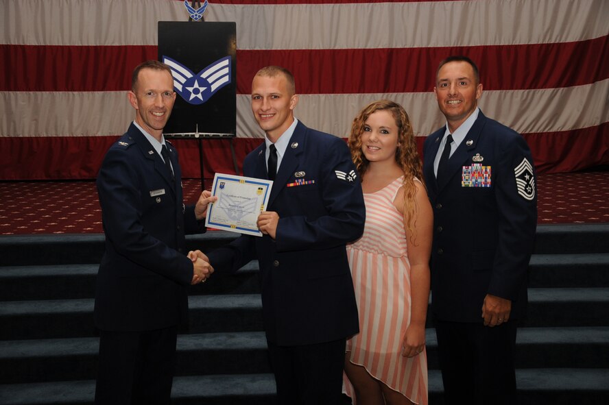 Senior Airman Bradley Boyd, 2nd Aircraft Maintenance Squadron, receives a certificate of promotion from Col. Leland Bohannon, 2nd Bomb Wing vice commander, and Chief Master Sgt. Curtis Storms, 2nd Bomb Wing command chief, during the September Wing Promotion Ceremony on Barksdale Air Force Base, La., Sept. 30, 2013. (U.S. Air Force photo/Senior Airman Sean Martin)

