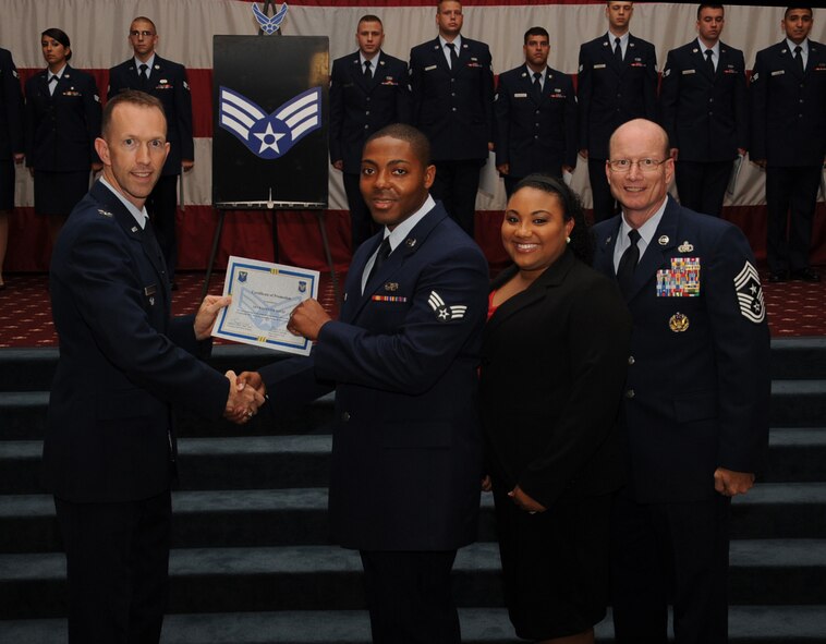 Senior Airman Willester House, 608th Aerospace Communications Squadron, receives a certificate of promotion from Col. Leland Bohannon, 2nd Bomb Wing vice commander, and Chief Master Sgt. Terry West, 8th Air Force  command chief, during the September Wing Promotion Ceremony on Barksdale Air Force Base, La., Sept. 30, 2013. (U.S. Air Force photo/Senior Airman Sean Martin)