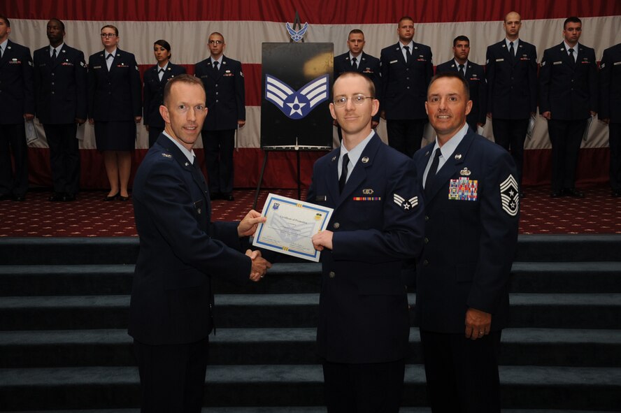 Senior Airman Anthony Dawson, 26th Operational Weather Squadron, receives a certificate of promotion from Col. Leland Bohannon, 2nd Bomb Wing vice commander, and Chief Master Sgt. Curtis Storms, 2nd Bomb Wing command chief, during the September Wing Promotion Ceremony on Barksdale Air Force Base, La., Sept. 30, 2013. (U.S. Air Force photo/Senior Airman Sean Martin)