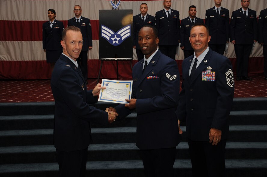 Senior Airman Shaphan Cartwright, 2nd Medical Support Squadron, receives a certificate of promotion from Col. Leland Bohannon, 2nd Bomb Wing vice commander, and Chief Master Sgt. Curtis Storms, 2nd Bomb Wing command chief, during the September Wing Promotion Ceremony on Barksdale Air Force Base, La., Sept. 30, 2013. (U.S. Air Force photo/Senior Airman Sean Martin)