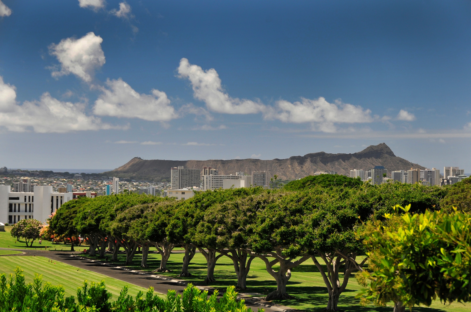 Members of the 134th Air Refueling Wing Civil Engineer Squadron and Public Affairs paid thier respects at  the National Memorial Cemetery of the Pacific better known as "The Punchbowl" during a deployment to Joint Base Pearl Harbor-Hickam, Hawaii  August 03-17. Diamond Head crater can be seen in the background.  (U.S. Air National Guard photo by Master Sgt. Kendra M Owenby/Released)