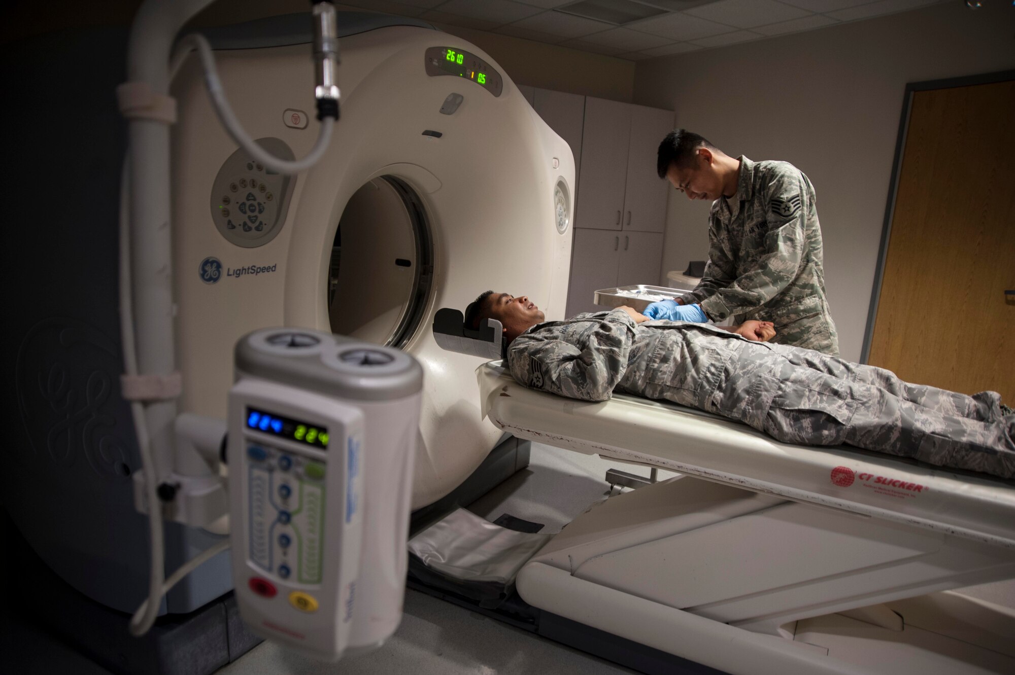 Staff Sgt. Christian Bagtas demonstrates how to do a computed tomography (CT) scan at the Wilford Hall Ambulatory Surgical Center, Joint Base San Antonio-Lackland, Oct. 1, 2013. A new scheduling system for radiology services provided by San Antonio Military Health System facilities has saved the Air Force more than $1 million and improved patient's access to care. Bagtas is a diagnostic imaging technologist assigned to the 59th Radiology Squadron. (U.S. Air Force photo/Staff Sgt. Corey Hook)