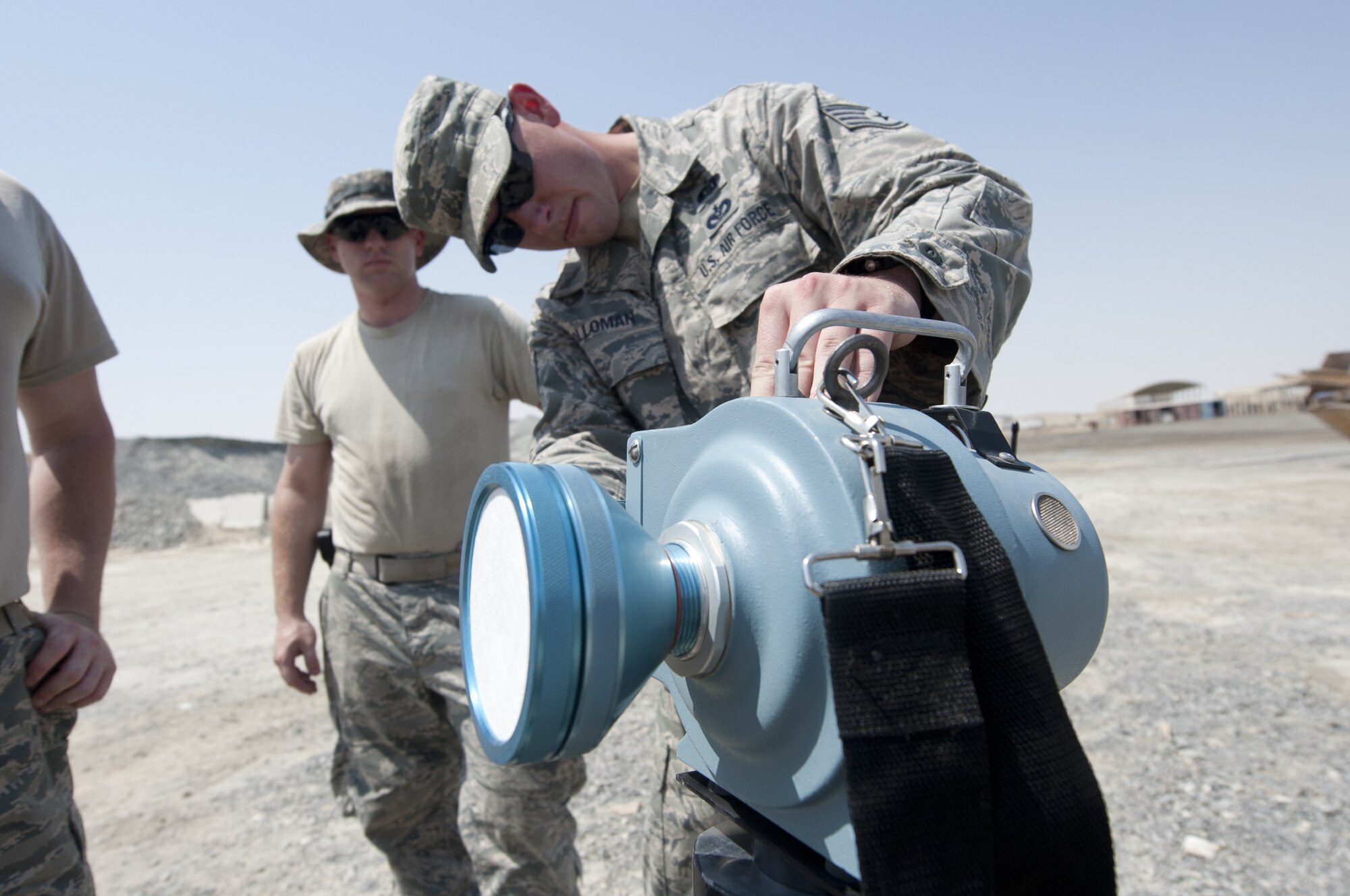 Staff Sgt. Joshua Holloman, 380th Expeditionary Civil Engineer Squadron emergency management craftsman, turns on a radiological air sampling device on scene of an exercise chemical threat area at an undisclosed location in Southwest Asia Sept. 20, 2013. The air sampling is part of the response procedures for emergency management personnel. Holloman calls Sumter, S.C., home and is deployed from Joint Base McGuire-Dix-Lakehurst, N.J. (U.S. Air Force photo by Staff Sgt. Jacob Morgan/Released)