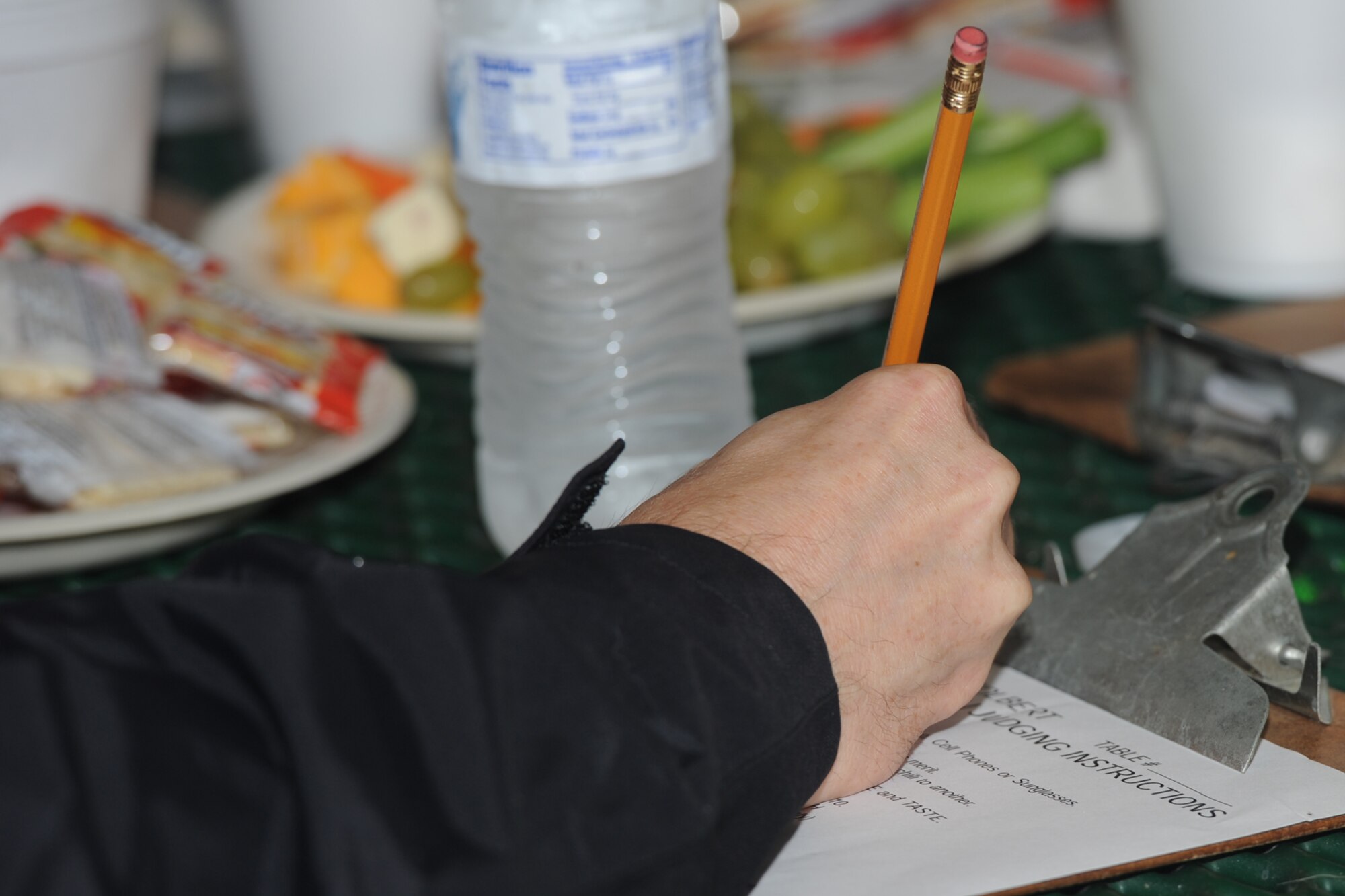 SAN ANGELO, Texas -- A judge writes down his or her critique during the 40th Annual Armed Forces Chili Cookoff at the Goodfellow Air Force Base Recreation Camp Sept. 28. Some of the categories being judged were beans, “anything goes” chili, Terlingua chili, brisket and chicken. (U.S. Air Force photo by Staff Sgt. Laura R. McFarlane)