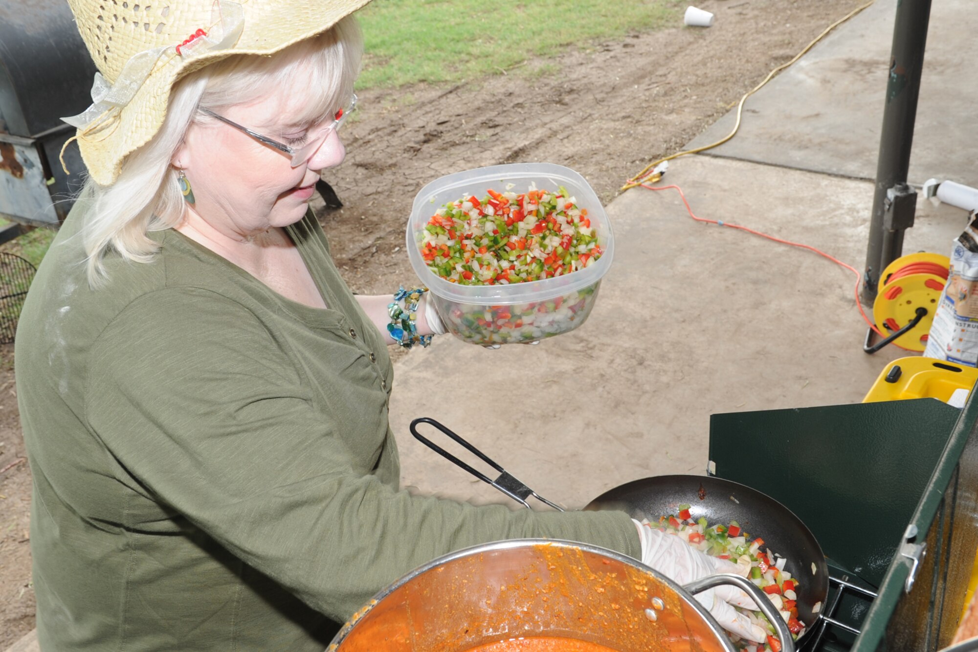 SAN ANGELO, Texas -- Joyce Eastwood, Preparers of Edible Tasty Animals team member, sautés vegetables before putting them in the teams chili during the 40th Annual Armed Forces Chili Cookoff at the Goodfellow Air Force Base Recreation Camp Sept. 28. Team PETA entered into the “anything goes” chili, Terlingua chili, chicken and brisket categories of the cook-off. (U.S. Air Force photo by Staff Sgt. Laura R. McFarlane)