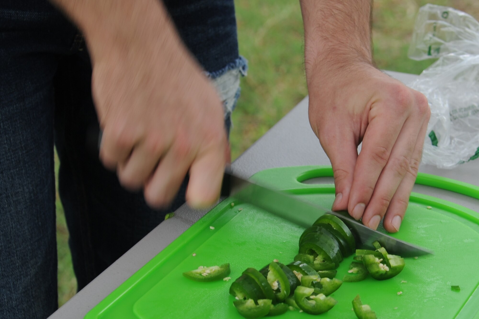 SAN ANGELO, Texas -- Airman Houston Jones, 315th Training Squadron student, cuts jalapenos for his team’s chili during the 40th Annual Armed Forces Chili Cookoff at the Goodfellow Air Force Base Recreation Camp Sept. 28. The chili cookoff began at Goodfellow in 1974 as a morale builder for the base members. (U.S. Air Force photo by Staff Sgt. Laura R. McFarlane)
