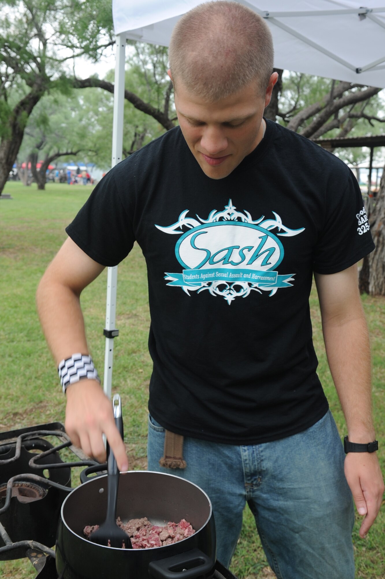 SAN ANGELO, Texas -- Airman 1st Class Nigel Hall, 315th Training Squadron student, cooks hamburger meat for his team’s chili during the 40th Annual Armed Forces Chili Cookoff at the Goodfellow Air Force Base Recreation Camp Sept. 28. His team, Teal Team Six, entered into the “anything goes” chili category of the cook-off. (U.S. Air Force photo by Staff Sgt. Laura R. McFarlane)
