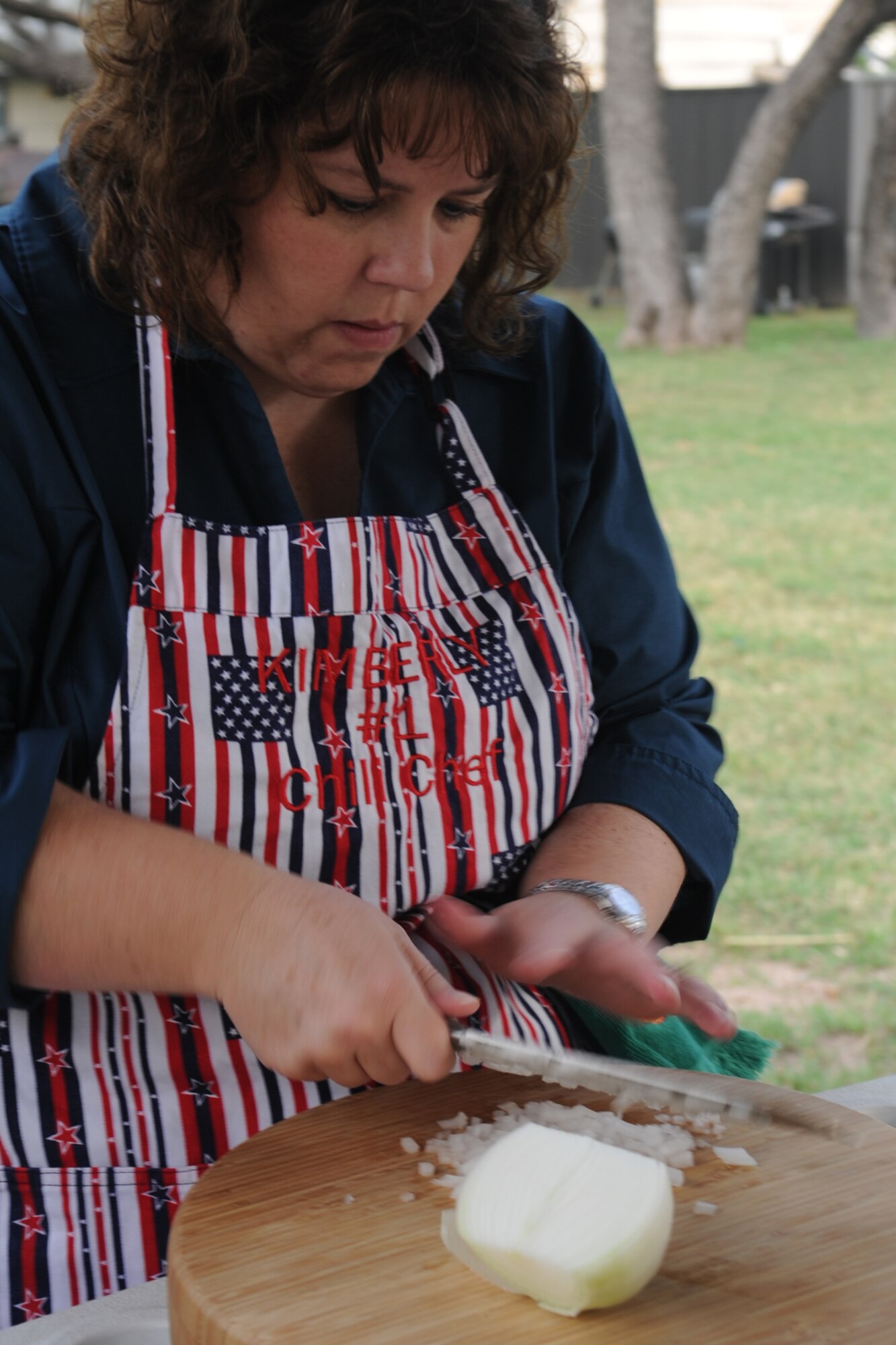 SAN ANGELO, Texas -- Kimberly Allen, chili cookoff participant, cuts onions for her and her husband’s chili during the 40th Annual Armed Forces Chili Cookoff at the Goodfellow Air Force Base Recreation Camp Sept. 28. Her team, the Red, White and True, entered their chili into the “anything goes” chili category of the cook-off. (U.S. Air Force photo by Staff Sgt. Laura R. McFarlane)