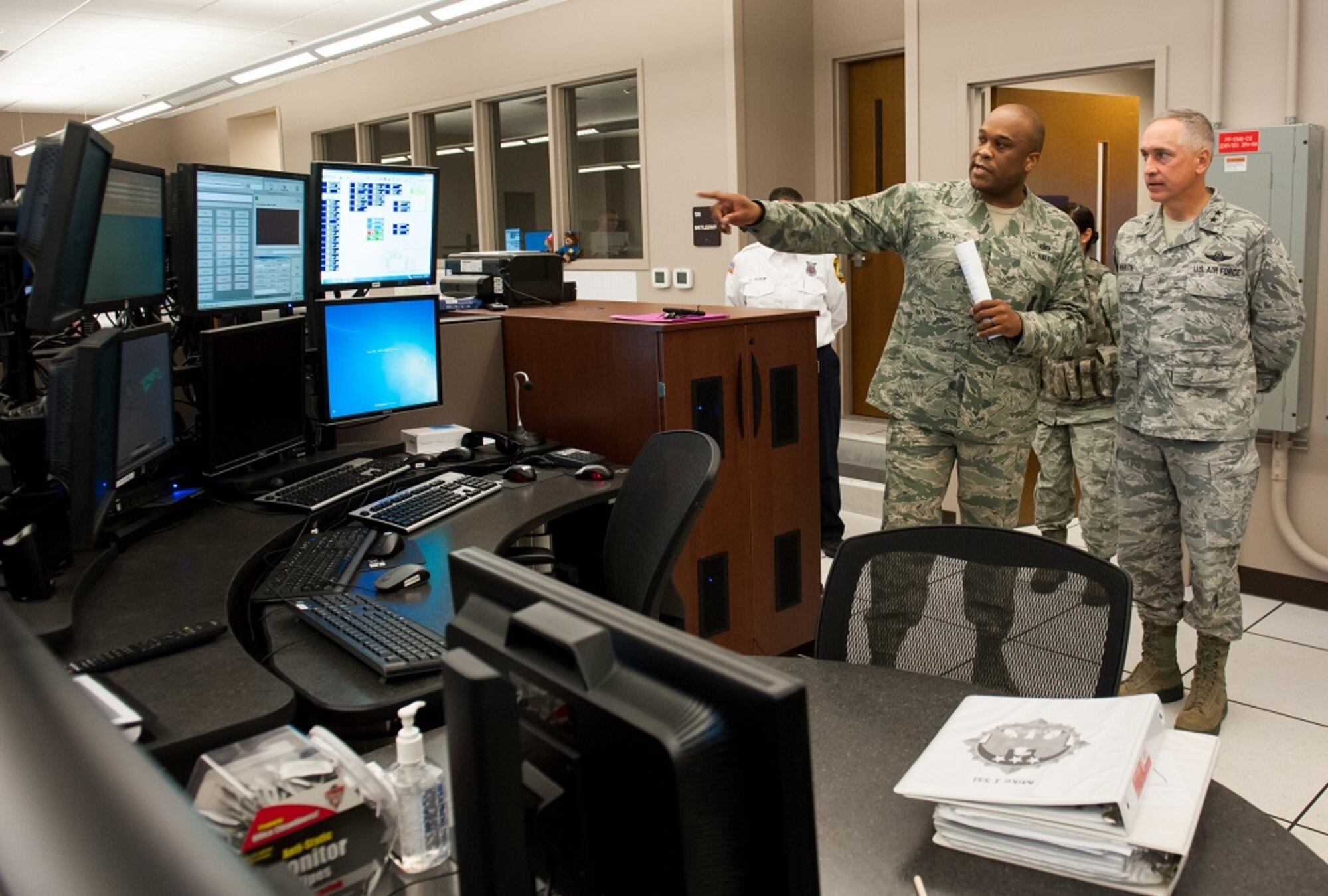 Tech. Sgt. Duwayne McCoy, 87th Security Forces Squadron Police Services noncommissioned officer in charge, explains how security forces members perform their duties to Maj. Gen. Frederick H. “Rick” Martin, U.S. Air Force Expeditionary Center commander, Sept. 30, 2013, at the Base Defense Operations Center, Joint Base McGuire-Dix-Lakehurst, N.J. Martin toured the BDOC during his base immersion tour after assuming command of the EC. (U.S. Air Force photo by Russ Meseroll/Released)