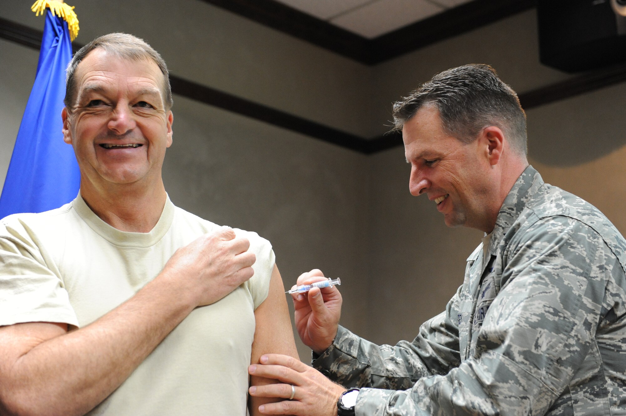Brig. Gen. Patrick Higby, 81st Training Wing commander, administers a flu shot to Brig. Gen. Kory Cornum during the Wing staff meeting Oct. 2, 2013, Keesler Air Force Base, Miss. The 81st Medical Operations Squadron Immunizations Clinic at the medical center is open to all active-duty, dependents, retirees and Department of Defense employees. (U.S. Air Force photo by Airman 1st Class Stephan Coleman)