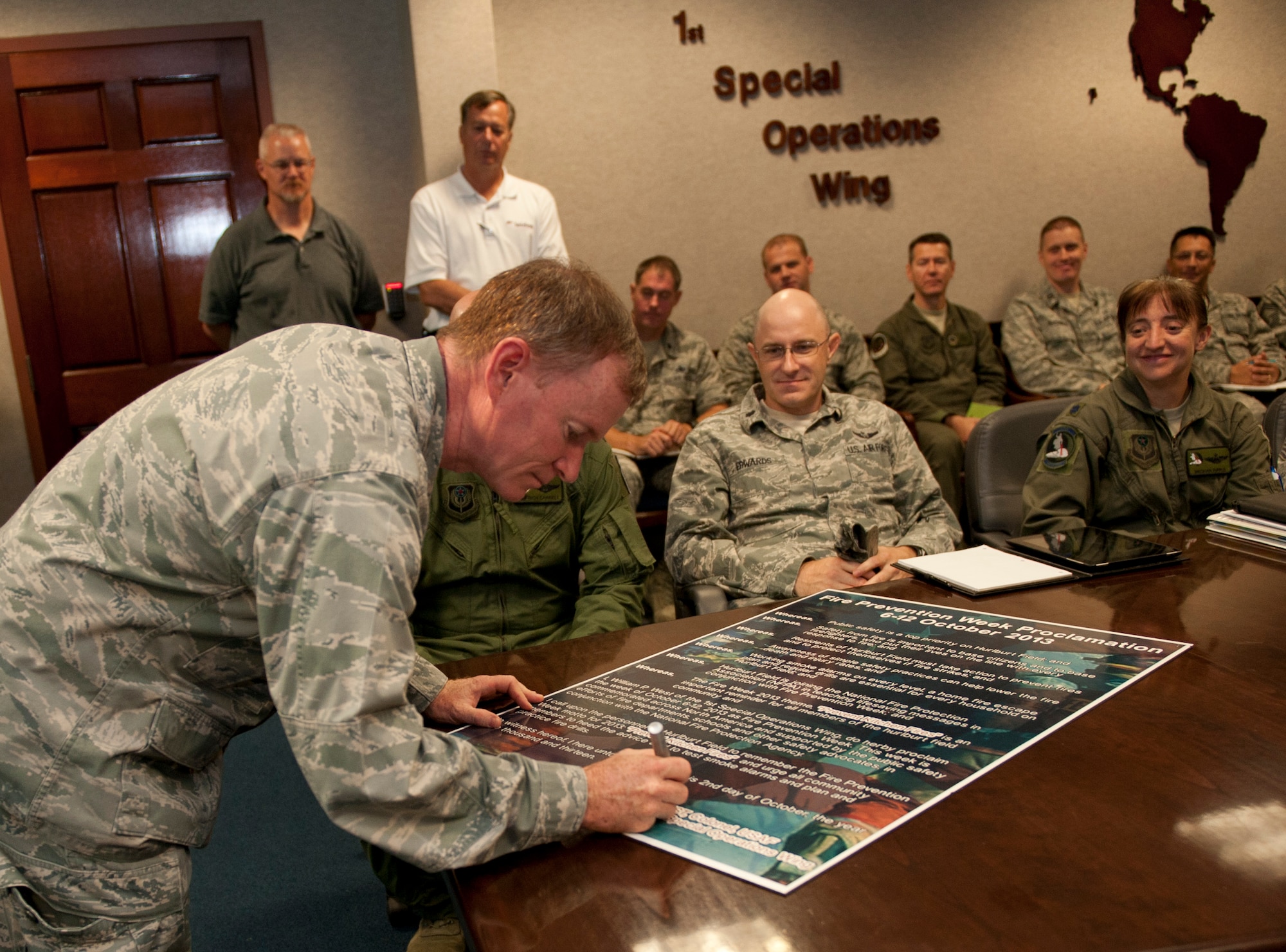 Col. William West, 1st Special Operations Wing commander, signs a fire prevention week proclamation in the wing conference room on Hurlburt Field, Fla., Oct. 2, 2013. The proclamation designated Oct. 6 through 12 as Fire Prevention Awareness Week. (U.S. Air Force photo/Krystal M. Garrett)
