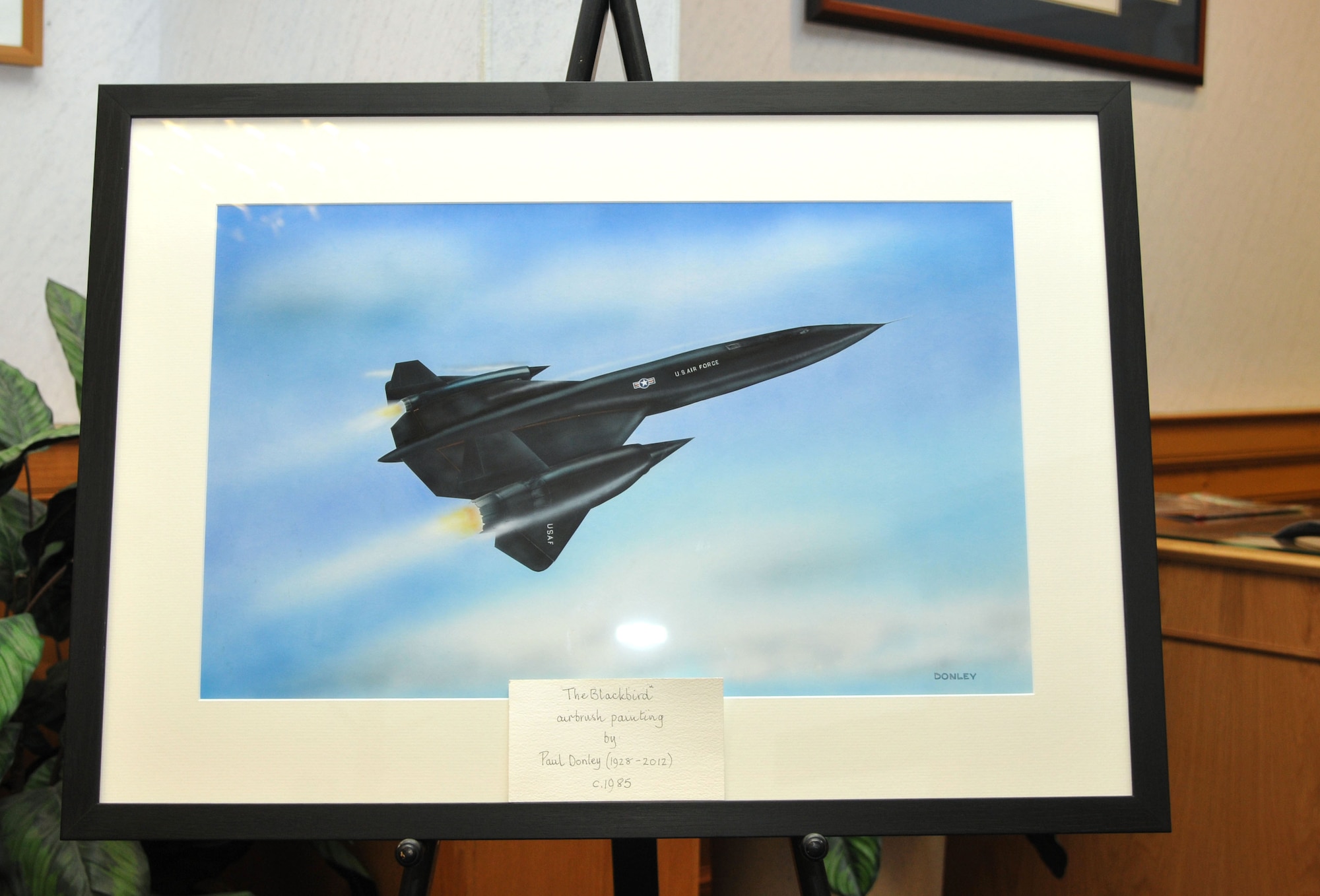 Jill Donley presented the 100th Air Refueling Wing her husband’s painting, “The Blackbird,” Oct. 2, 2013, at RAF Mildenhall, England. The painting, created in 1985, is of an SR-71B Blackbird. The SR-71B Blackbird flew out of RAF Mildenhall for more than 20 years. (U.S. Air Force photo by Airman 1st Class Kelsey Waters/Released)