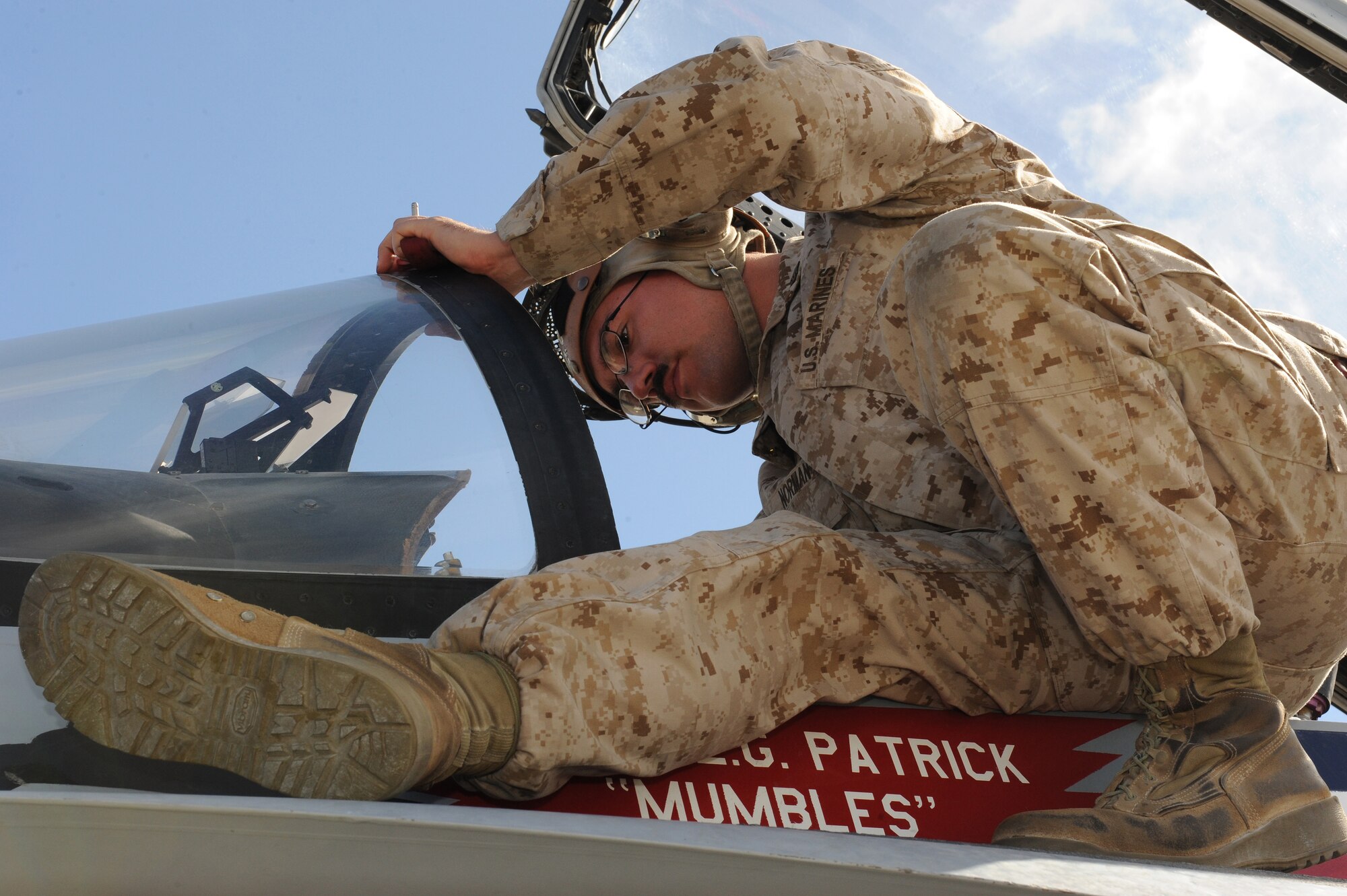 U.S. Marine Corps Sgt. William Norman, Marine Fighter Attack Squadron 115 maintainer, checks the cockpit of an F/A-18 Hornet after landing Oct. 2, 2013, at Lajes Field, Azores. The Marines will take crew rest and refuel, then leave for VMFA-115 at Marine Corps Air Station, Beaufort, S.C. (U.S. Air Force photo by Guido Melo/Released)