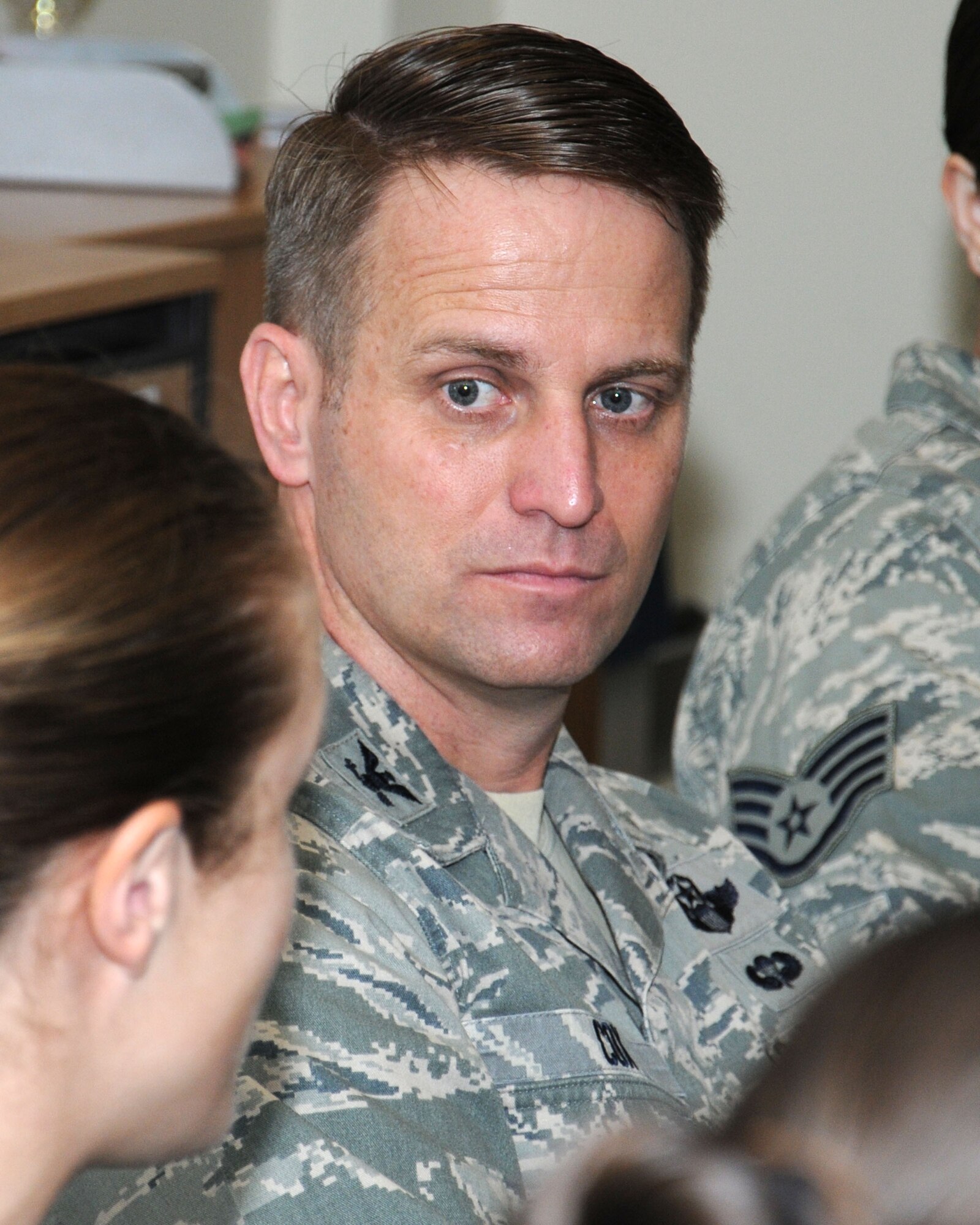 U.S. Air Force Col. David Cox, 100th Air Refueling Wing vice commander, speaks with personnel from the Sexual Assault Prevention and Response office and Team Mildenhall victim advocates in the SAPR office Oct. 3, 2013, on RAF Mildenhall, England. The group discussed many topics including alcohol in the dormitories. (U.S. Air Force photo by Gina Randall/Released)