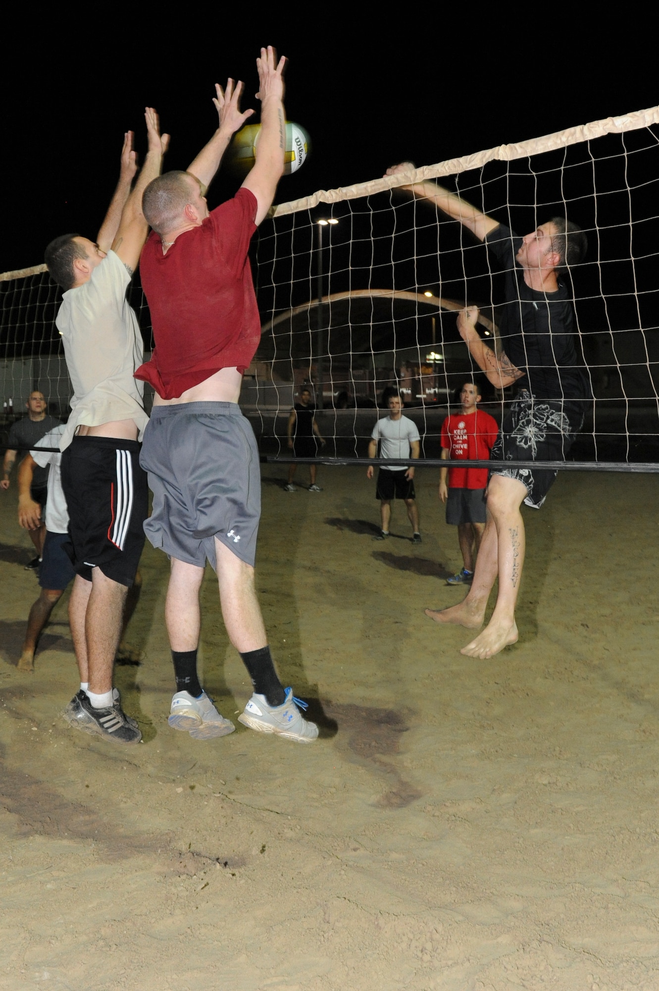 Two members of the Force Protection 1 volleyball team block Wesley Farber, CEX/CEF head coach, during the championship game at an undisclosed location in Southwest Asia Sept 30, 2013. Both teams played through a tournament style playoff before playing each other in the final game. Farber is native to Coral Springs, Fla., and is deployed from Eielson Air Force Base, Alaska. (U.S. Air Force photo by Staff Sgt. Joshua J. Garcia) 