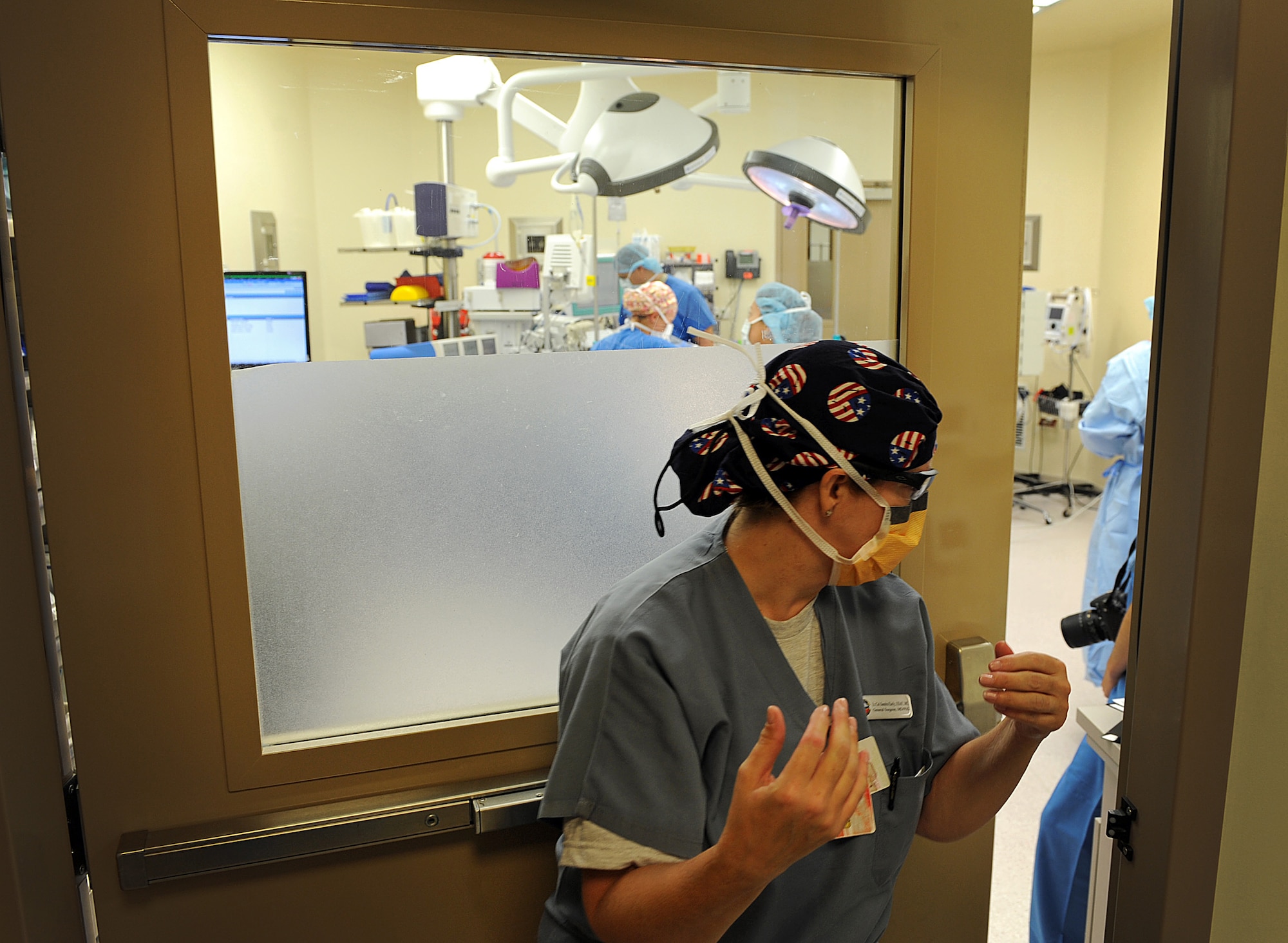 Lt. Col. (Dr.) Sandra Early, 31st Surgical Operations Squadron medical director of surgical services, walks into the operating room, Sept. 25, 2013, at Aviano Air Base, Italy. Before a surgeon can operate, they must sterilize themselves and done protective gear to reduce the risk of infection to patients. (U.S. Air Force photo/Airman 1st Class Matthew Lotz)