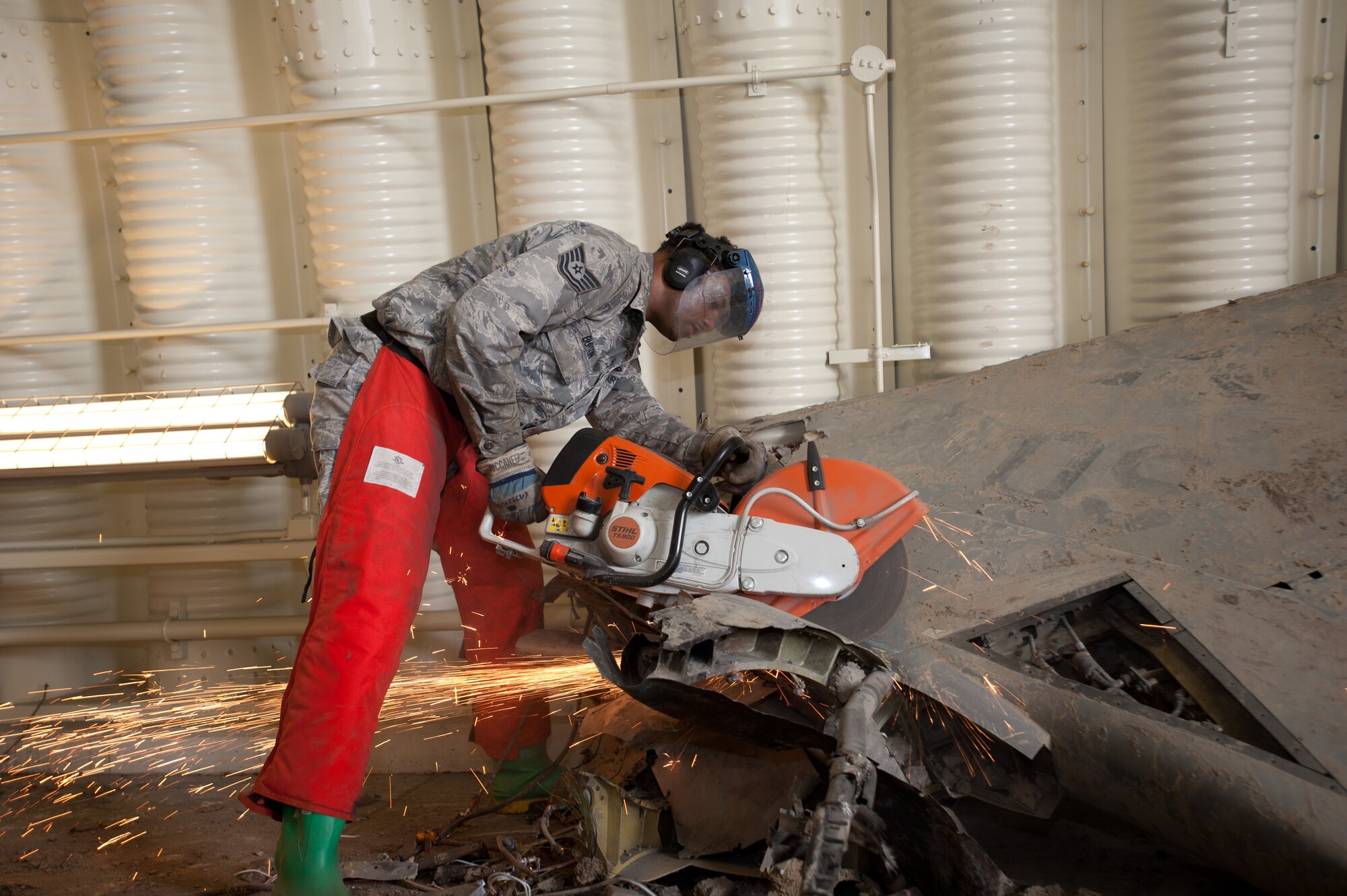 Tech. Sgt. Marvin Burton, 8th Maintenance Squadron Crash Damaged or Disabled Aircraft Recovery team chief, saws into the tail of a crashed F-16 Fighting Falcon at Kunsan Air Base, Republic of Korea, July 29, 2013. Crashed assets at Kunsan were taking up room in storage, which affected the base’s ability to accept follow-on forces. Burton and his team supported the effort to free up space by cutting the Falcon into manageable and shippable pieces. (U.S. Air Force photo by Senior Airman Armando A. Schwier-Morales/ Released)