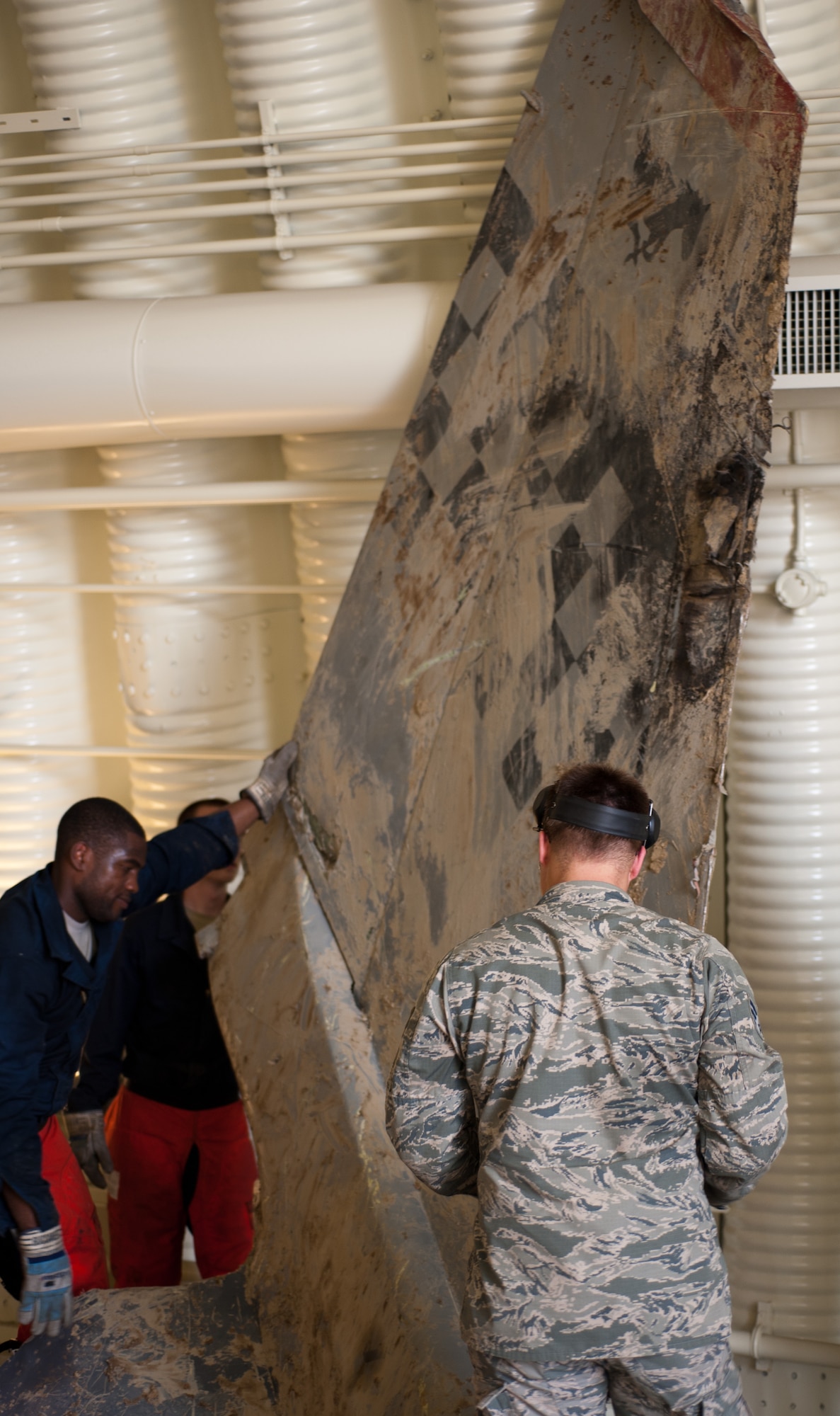 The tail of a crashed F-16 Fighting Falcon is moved by Airmen from the 8th Maintenance Squadron Crash Damage Disabled Aircraft Recovery team to ensure the part is stabilized before cutting into pieces at Kunsan Air Base, Republic of Korea, July 29, 2013. Training to do their job on a crashed F-16 Fighting Falcon allowed the CDDAR team to train outside the classroom. (U.S. Air Force photo by Senior Airman Armando A. Schwier-Morales/ Released) 