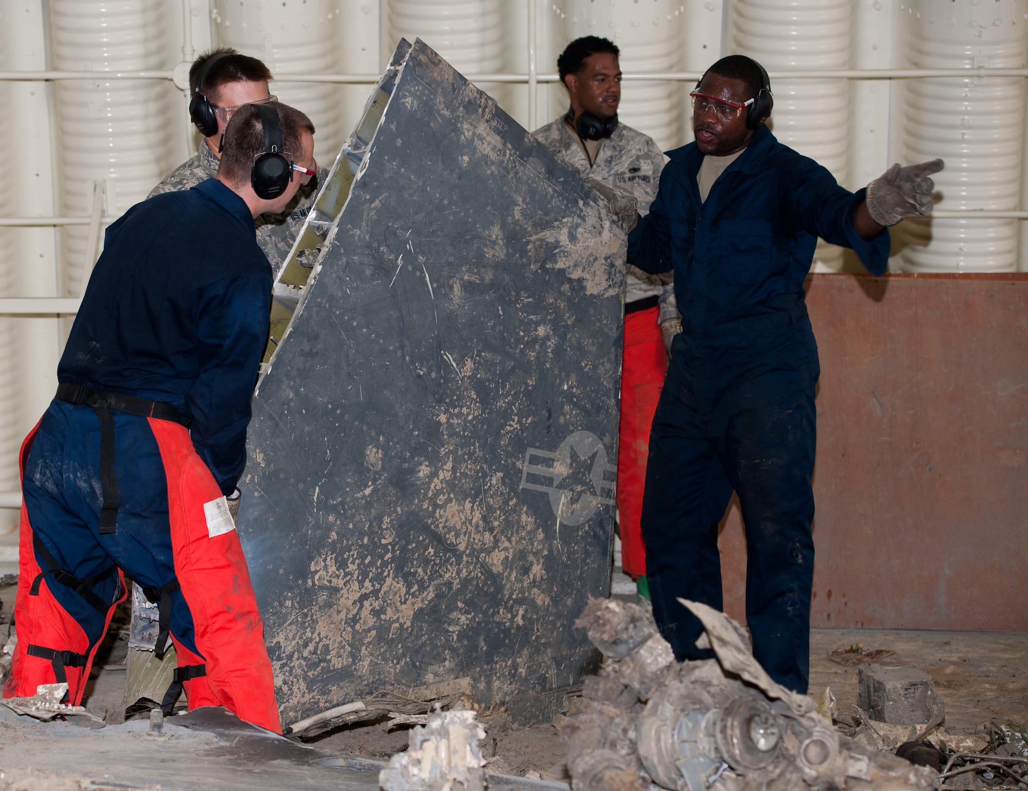 Crash, Damaged or Disabled Aircraft Recovery Airmen from the 8th Maintenance Squadron prepare to move part of an F-16 Fighting Falcon at Kunsan Air Base, Republic of Korea, July 29, 2013. The Airmen cut a downed aircraft into smaller pieces to create more space on the Kunsan flightline. (U.S. Air Force photo by Senior Airman Armando A. Schwier-Morales/ Released)
