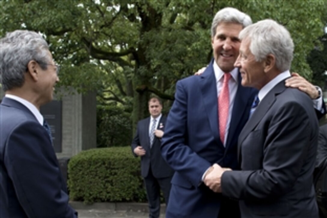 U.S. Defense Secretary Chuck Hagel, right, greets U.S. Secretary of State John F. Kerry at the Chidorigafuchi National Cemetery in Tokyo, Oct. 3, 2013. Hagel and Kerry laid flowers at the cemetery’s central tomb. 