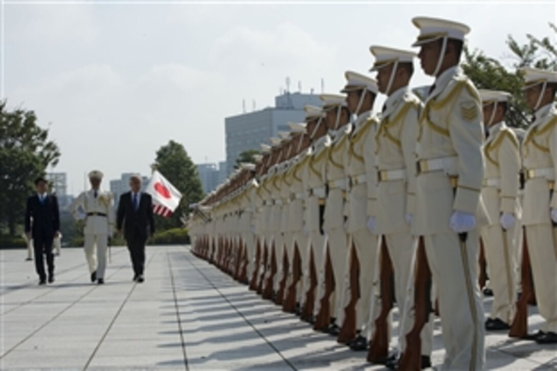 Japanese Defense Minister Itsunori Onodera escorts U.S. Defense Secretary Chuck Hagel during a pass-in-review ceremony in Tokyo, Oct. 3, 2013. The two counterparts later met to discuss issues of mutual importance.