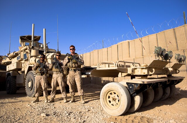 Cpls. Andrew Salabarria (left), Lee Walls, and Adam Stanek, the crew of the navigation vehicle for Combat Logistics Regiment 2, Regional Command (Southwest), pose for a photo in front of their Mine Resistant, Ambush Protected vehicle at Forward Operating Base Shir Ghazi, Helmand province, Afghanistan, Sept. 16, 2013. The navigation team led Marines through rugged desert terrain while they cleared routes for convoys of up to 40 vehicles.