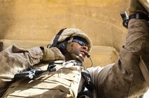 Cpl. Andrew Salabarria, a Staten Island, N.Y., native and turret gunner with Combat Logistics Regiment 2, Regional Command (Southwest), peers out of the turret in his Mine Resistant, Ambush Protective vehicle during a convoy through Helmand province, Afghanistan, Sept. 16, 2013. Salabarria serves as the gunner for the navigation vehicle responsible for charting routes through Afghan villages and barren deserts throughout the province.