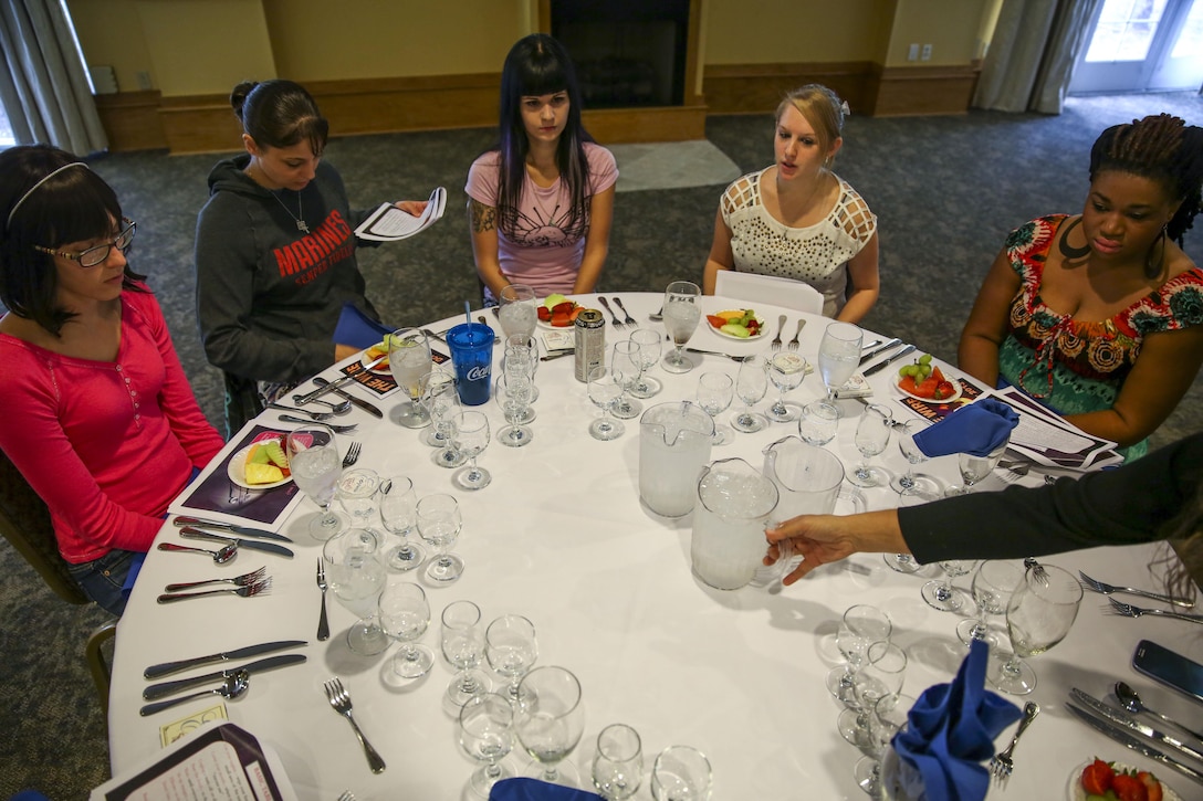 Spouses practice ball etiquette at the Officers' Club aboard Marine Corps Air Station Beaufort, Sept. 26, in preparation for the 238th Marine Corps Birthday Ball. The class was a part of Operation Ball Gown, where spouses of where able to receive a free ball gown for the Marine Corps Ball. 