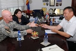 Army Brig. Gen. Mike Bridges, left, assistant adjutant general for Army, Alaska Army National Guard, exchanges gifts with Dumaa Namsrai, right, deputy chief of the Mongolia National Emergency Management Agency at the NEMA office in Ulaanbaatar, Mongolia, Aug. 13, 2012. Bridges attended the meeting while in Mongolia as part of the National Guard State Partnership Program.