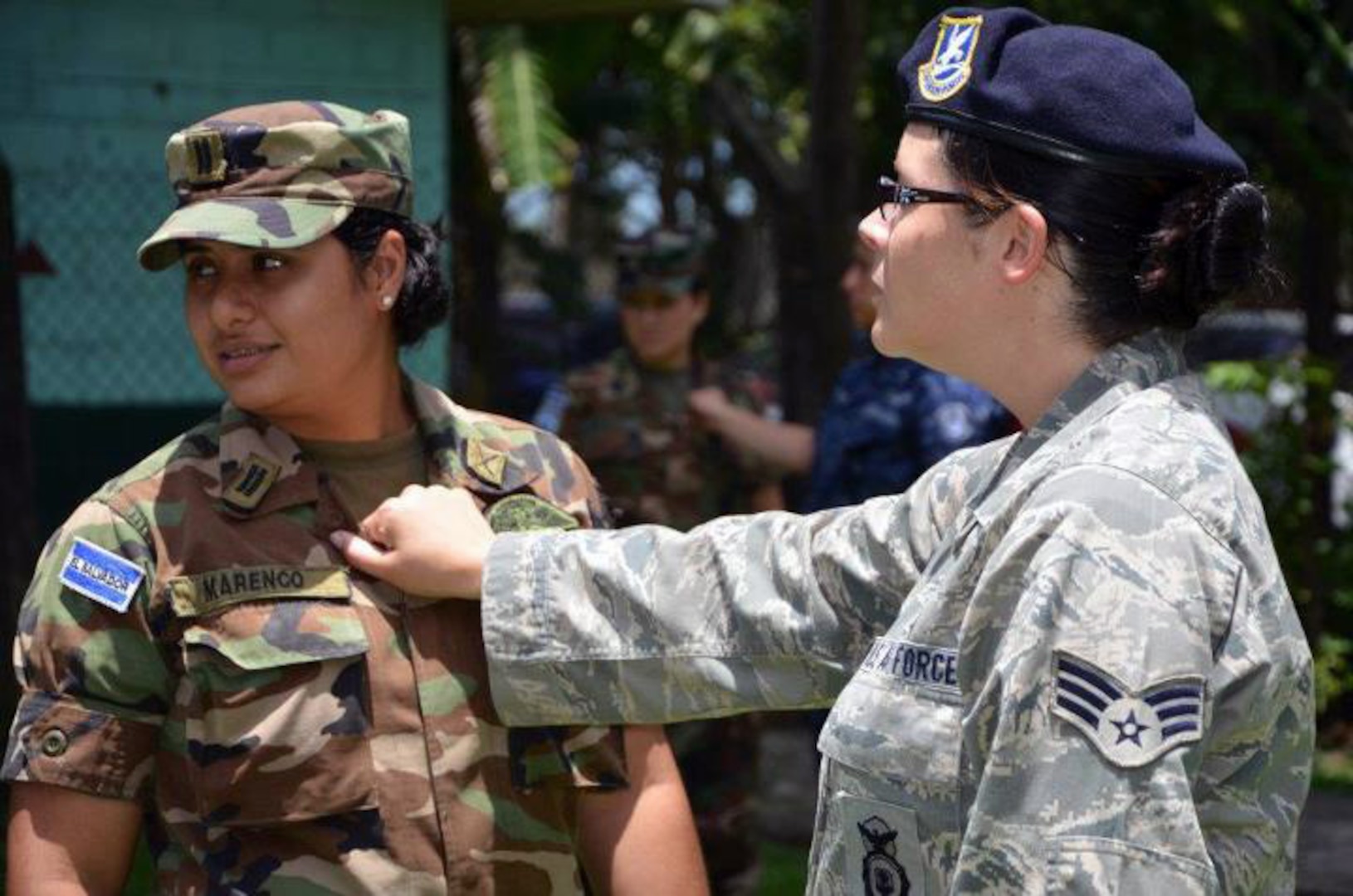 1st Lt. Carolina Marenco of the Salvadoran army and Senior Airman Heather Gagnon of the New Hampshire National Guard's 157th Security Forces Squadron, demonstrates a self defense technique during a military police exercise in Lourdes, El Salvador on Aug. 7, 2012.