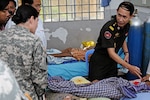 Cambodian Capt. Prum Sanghoun, a Royal Cambodian Armed Forces doctor, explains the care of a patient to Army Staff Sgt. Erin Smith, a medic with the Idaho National Guard's Charlie Company, 145th Brigade Support Battalion, during a tour of the Phnom Penh Military Hospital June 27, 2012. The Idaho National Guard conducted the subject matter expert exchange as part of its ongoing relationship through the National Guard Bureau's State Partnership Program with the Royal Kingdom of Cambodia.