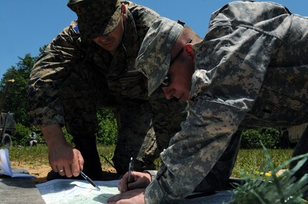 Armed Forces of Bosnia-Herzegovina Capt. Drgan Malic, left, company commander, and Army 1st Lt. Jeff Hartline, of Company C, 1st Battalion, 175th Infantry Regiment, plot out features on a map in order to complete a sand table for a combat lane exercise during training at Fort A.P. Hill, Va., June 15, 2012. AFBiH soldiers were embedded with Maryland Army National Guard units throughout the duration of training here and at Camp Dawson, W.V. Bosnia-Herzegovina and the Maryland National Guard are partnered through the National Guard Bureau's State Partnership Program.