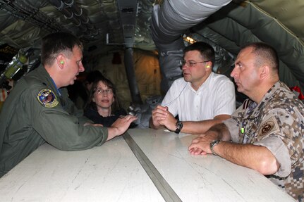 Valdis Dombrovskis, in white shirt, prime minister of Latvia, talks with U.S. and Latvian officials shortly after observing an air-to-air refueling operation from a Michigan Air National Guard KC-135 Stratotanker. The prime minister praised the ongoing relationship between Latvia and the Michigan National Guard that is a part of the National Guard Bureau’s State Partnership Program.