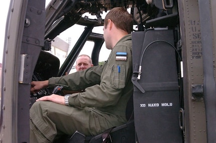 Army Col. Sean Casey, chief of staff of the Maryland National Guard, looks on as an Estonian air force pilot goes over the flight instruments of a UH-60 Black hawk helicopter at the Army Aviation Support Facility in Edgewood, Md., June 18, 2012. Two pilots with the Estonian air force have been training with the Maryland Army National Guard's C Company, 1st Battalion, 169th Aviation Regiment as part of the State Partnership Program, which pairs up National Guard units with partner nations worldwide. The Maryland Guard has been partnered with Estonia since 1993.