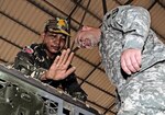 Royal Cambodian Armed Forces Maj. Srey Saran, left, shows a radiator problem he discovered to Army Staff Sgt. Daniel Wohlers, a vehicle maintenance instructor with the Idaho Army National Guard's Regional Training Site Maintenance Facility, during a preventative maintenance checks and services inspection May 17 near Phnom Penh, Cambodia. Wohlers was one of six vehicle maintenance and logistics experts from Idaho's RTSM to go on the subject matter expert exchange. The Idaho-Cambodia partnership began in 2009 and this is Wohlers' third visit to Cambodia.