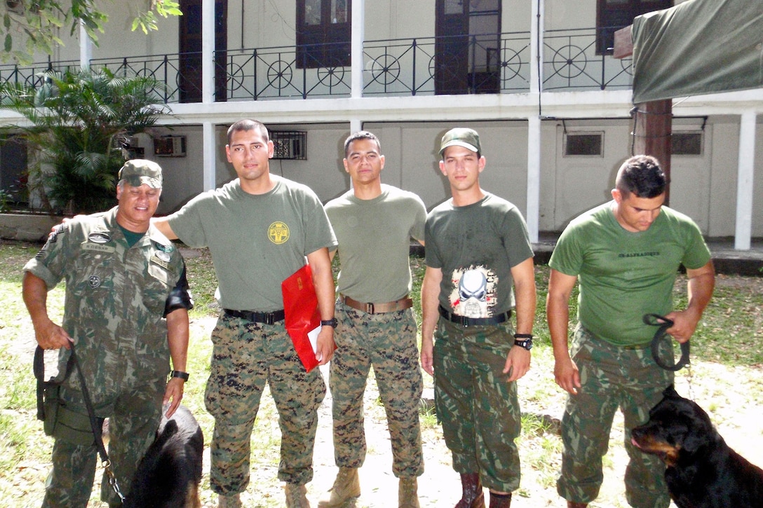 Petty Officer 2nd Class Andres Aguirre, second from left, hospital corpsman, Bravo Company, 1st Medical Battalion, 1st Marine Logistics Group, poses for a photo alongside military policeman from the Brazilian and U.S. Marine Corps during Brazil Law Enforcement Subject Matter Expertise Exchange exercise in Brazil, Sept. 20, 2013. Aguirre, who recently returned from the bilateral exercise in Brazil, is also a platoon sergeant in his company, responsible for approximately 100 sailors. 