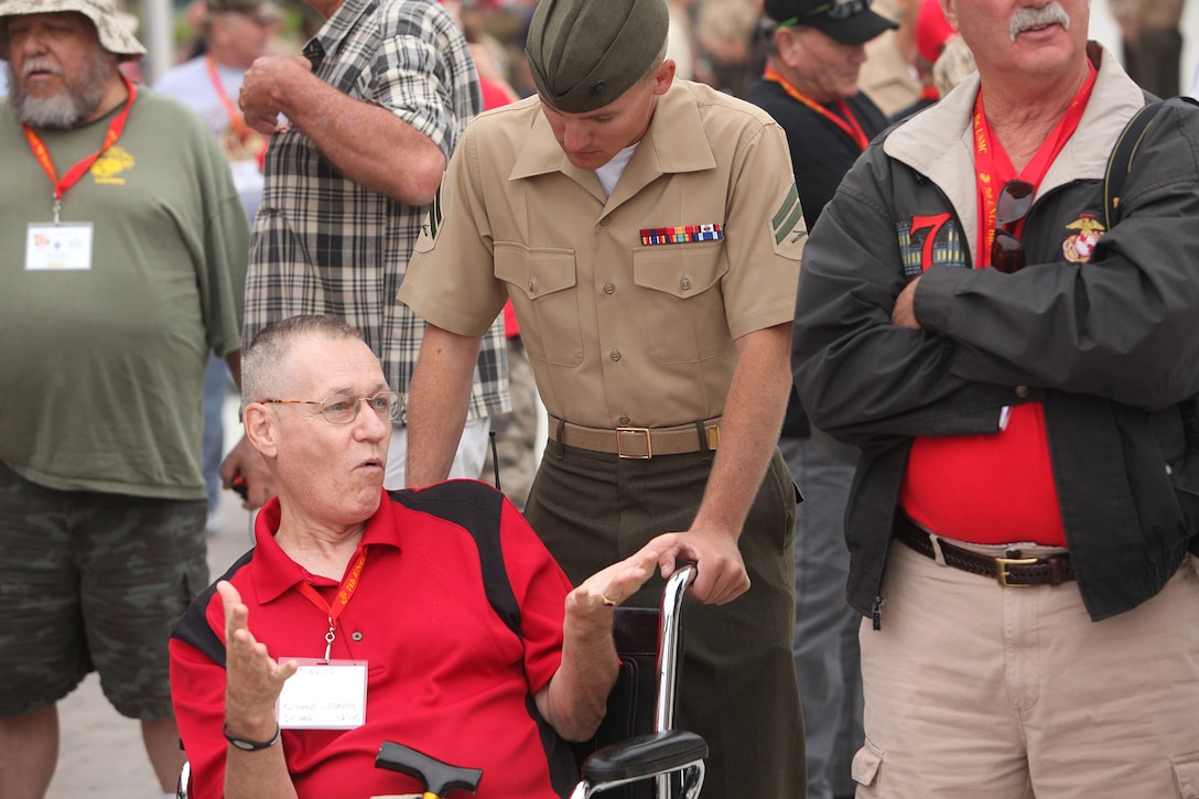 A Vietnam veteran speaks with a Marine from 7th Engineer Support Battalion, 1st Marine Logistics Group, during a reunion ceremony aboard Camp Pendleton, Calif., Sept. 20, 2013. The reunion included a full tour of the new barracks, a display of current issued gear, equipment demonstrations by Bridge Company and a luncheon in honor of the almost 200 Vietnam veterans who participated. 