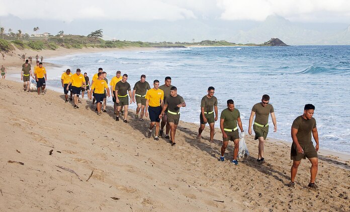 Marines and sailors with Marine Aviation Logistics Squadron 24 leave North Beach with bags full of trash after a beach clean up and run, Sept. 25, 2013. (U.S. Marine Corps photo by Lance Cpl. Nathan Knapke)