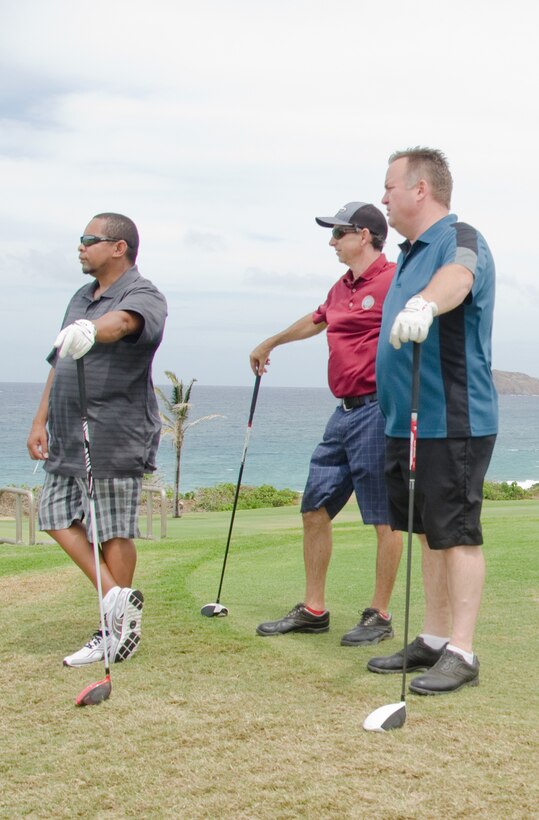 Frank Nagamine, Shane McEnroe and Jim Hamachek, manager, KahunaÕs Sports Bar and Grill, rest while their teammate, Brad Espinas (not shown), tees off during the CommanderÕs Cup Golf Classic at the Kaneohe Klipper Golf Course, Sept. 27, 2013. (U.S. Marine Corps photo by Kristen Wong)