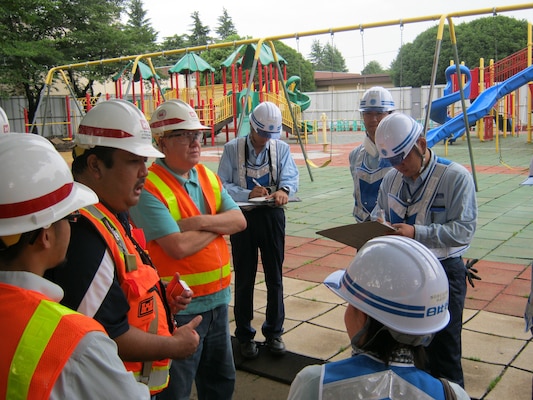 Representatives from the U.S. Army Corps of Engineers, Japan District’s Safety Office meet with Yokota Resident Office Quality Assurance staff and Hibiya Engineering at the project site for a classroom upgrade at Mendel Elementary School to ensure that all safety measures are in place before beginning demolition. The $9.6 million project currently underway at Yokota Air Force Base, Japan, includes the construction of a new classroom facility, playgrounds and covered walkways to connect the new addition to surrounding buildings.