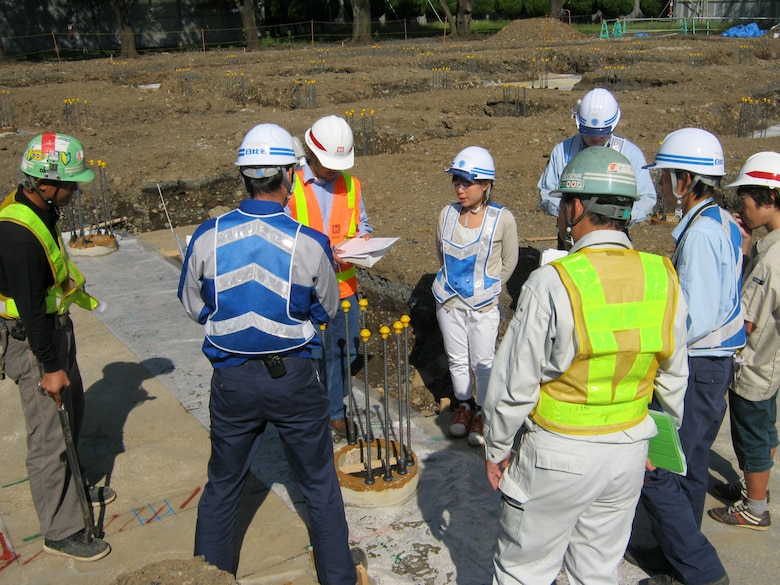 U.S. Army Corps of Engineers, Japan District Project Engineer Ruel Binonwangan and Construction Representative Yoji Abe conduct a meeting to discuss foundation work in support of a new classroom facility at Mendel Elementary School, Yokota Air Force Base, Japan.