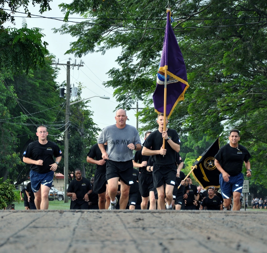 U.S. Army Col. Thomas Boccardi, Joint Task Force-Bravo commander, leads the way during an "Esprit de Corps" run at Soto Cano Air Base, Honduras, Oct. 4, 2013.  The formation run was conducted for servicemembers to exhibit pride and esprit de corps within the organization while improving physical fitness.  Boccardi addressed the servicemembers prior to the run and thanked them for their outstanding work and commitment to the mission of JTF-Bravo.  (U.S. Air Force photo by Capt. Zach Anderson)