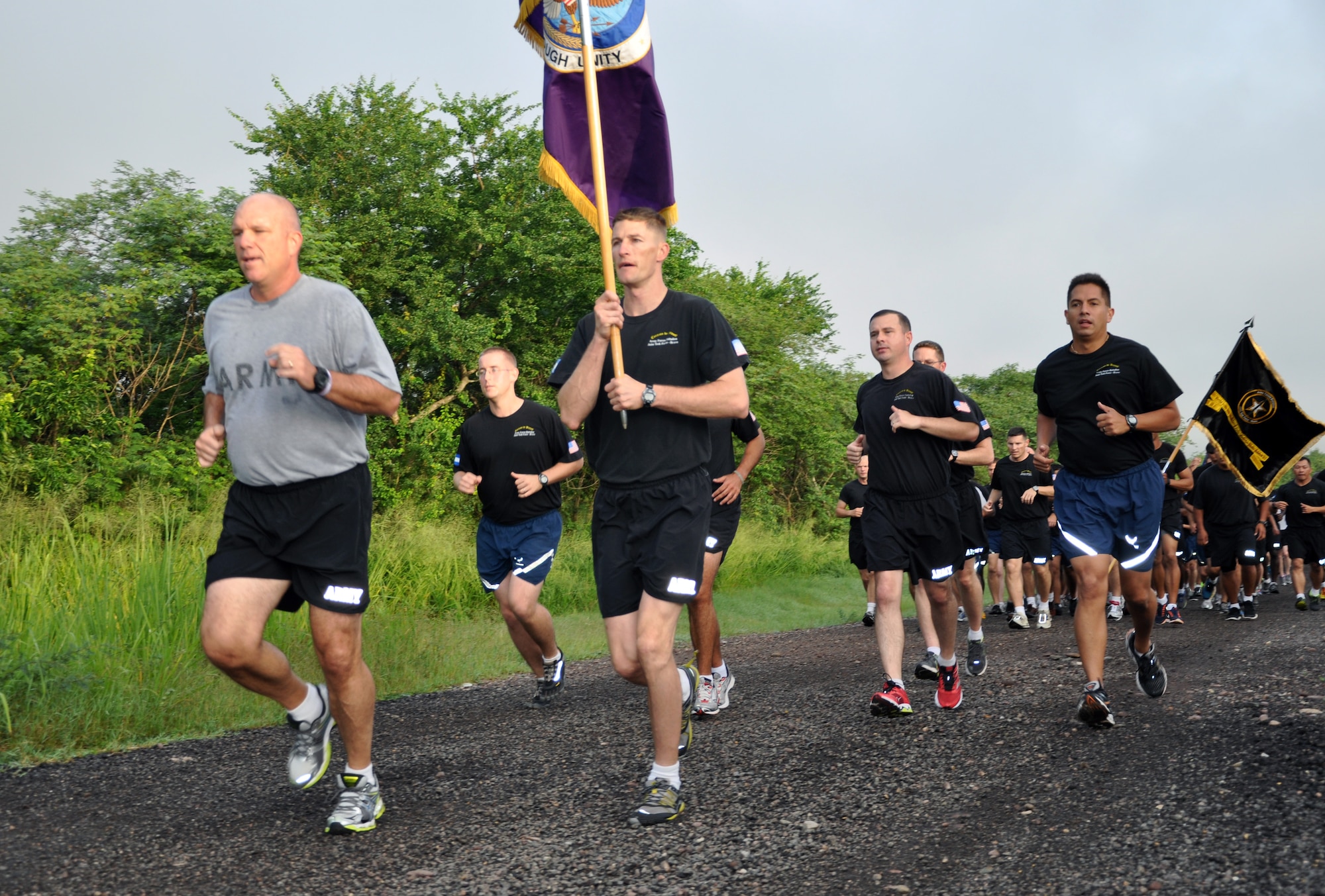 U.S. Army Col. Thomas Boccardi, Joint Task Force-Bravo commander, leads the way during an "Esprit de Corps" run at Soto Cano Air Base, Honduras, Oct. 4, 2013.  The formation run was conducted for servicemembers to exhibit pride and esprit de corps within the organization while improving physical fitness.  Boccardi addressed the servicemembers prior to the run and thanked them for their outstanding work and commitment to the mission of JTF-Bravo.  (U.S. Air Force photo by Capt. Zach Anderson)