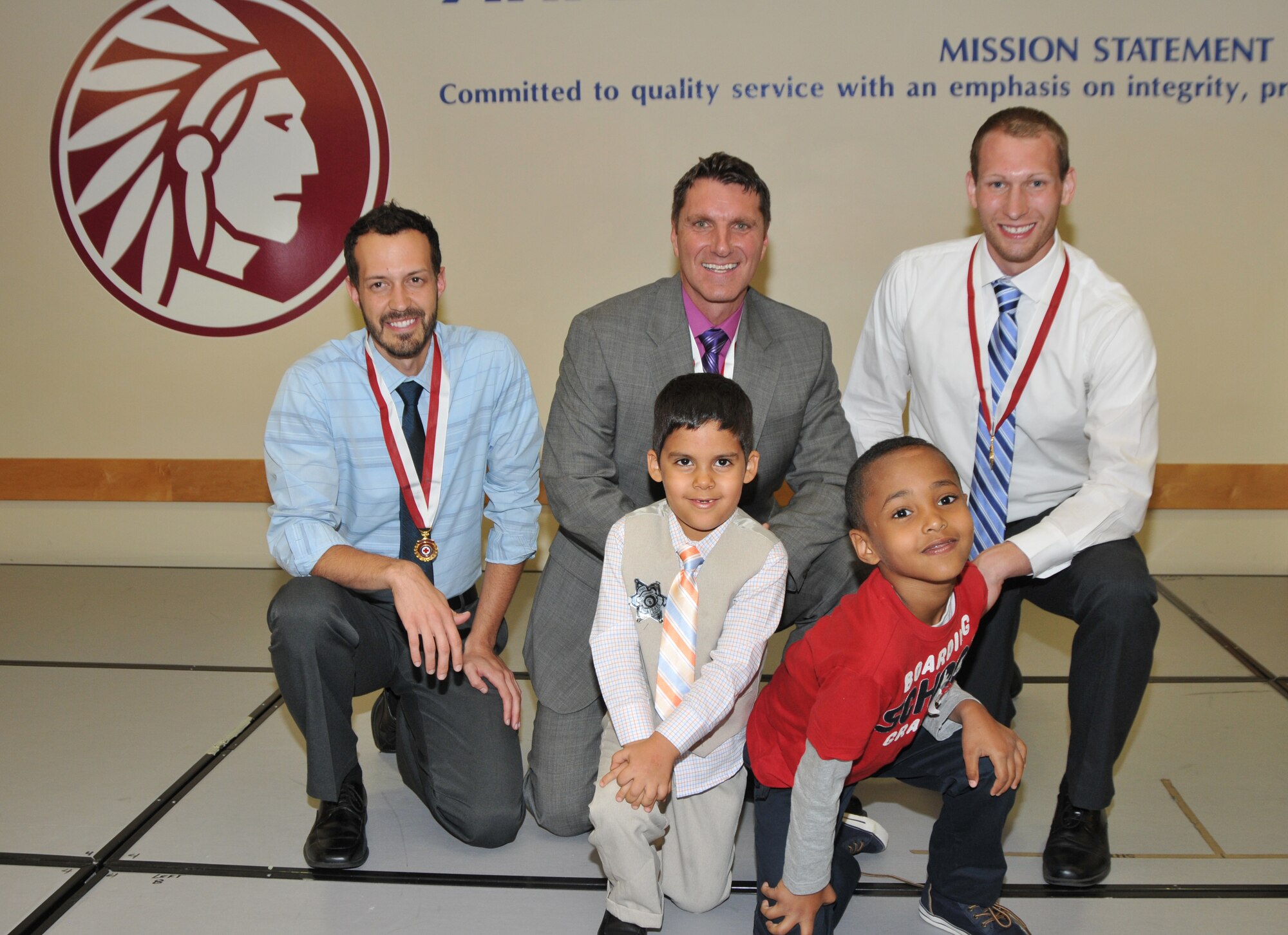 Sheriff's Office Lifesaving Award recipients (from left to right) Troy Steadman, Richard Mandeville, and Daniel bertram pose with Mutasen Masoud (left, front) and his friend Abrahrem after the awards ceremony at the Arapahoe County Sheriff's Office Oct. 1. Mandeville, Steadman, and Bertram rescued the boys from nearly drowning to death. (Courtesy of Arapahoe County Sheriff's Office)